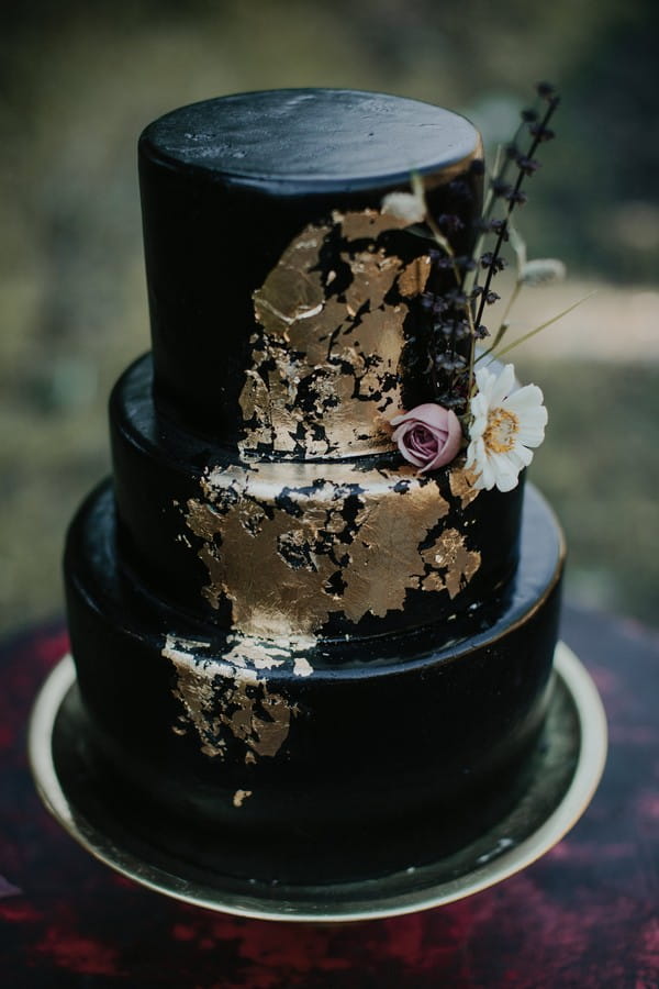 Black wedding cake with gold leaf