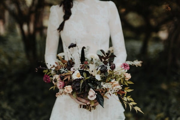 Bride holding autumn wedding bouquet