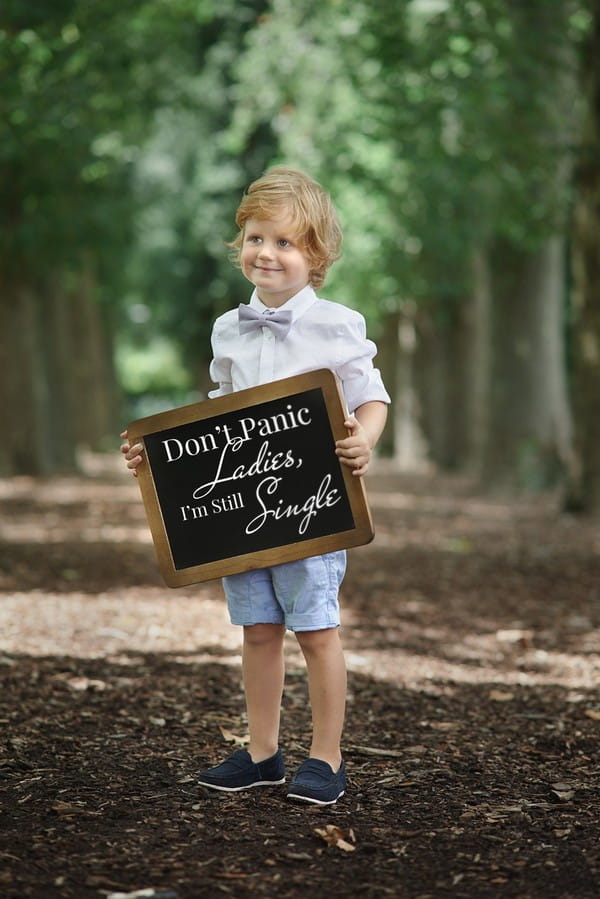 Pageboy holding wedding sign