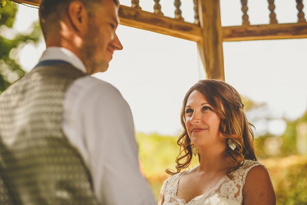 Bride looking at groom during wedding ceremony