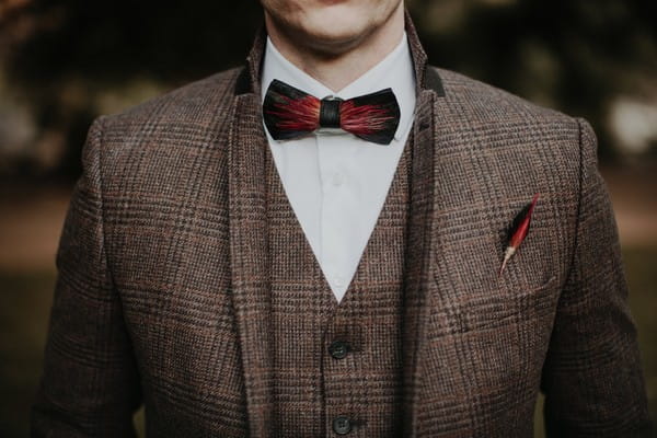 Tweed waistcoat and jacket with bow tie and feather buttonhole