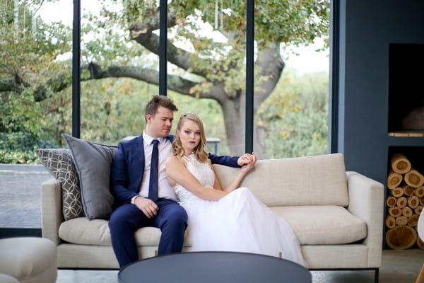 Bride and groom sitting on couch