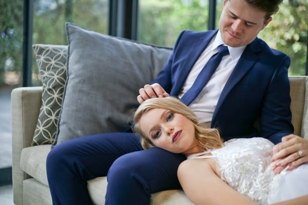 Bride laying with head in groom's lap