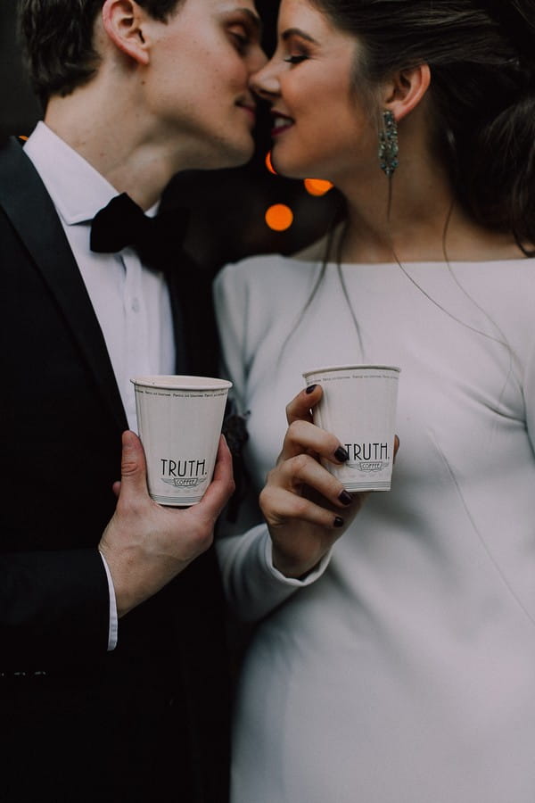 Bride and groom holding Truth coffee cups