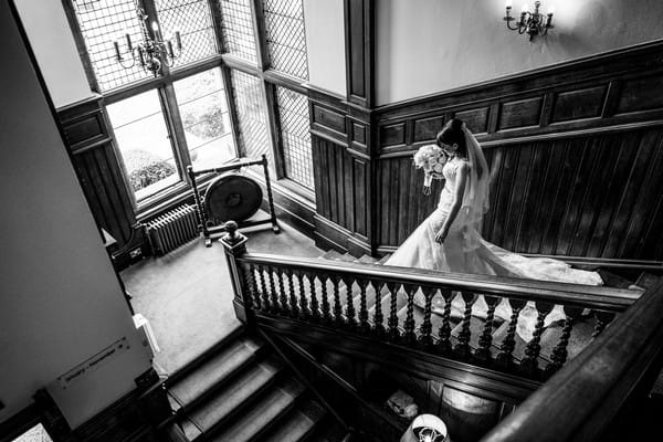 Bride walking down the stairs at wedding venue - Picture by Cris Lowis Photography