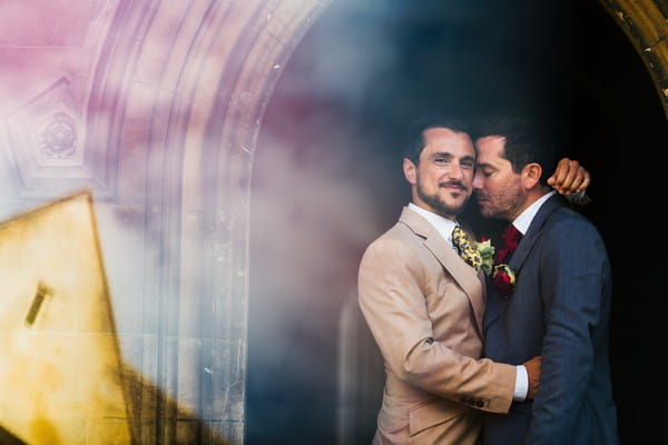 Grooms hugging outside Kings College in Cambridge - Picture by Rafe Abrook Photography