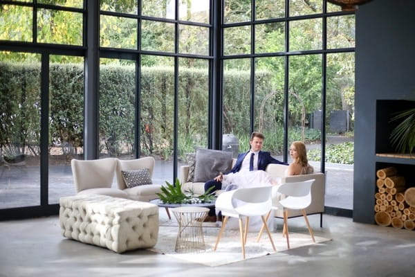 Bride and groom sitting in The Conservatory Franschhoek