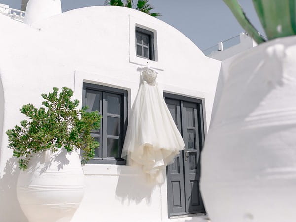 Wedding dress hanging outside apartment in Santorini