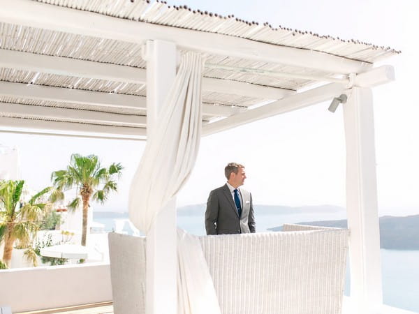 Groom waiting for bride before elopement in Santorini