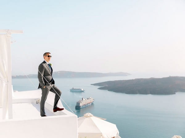 Groom standing with sea in background