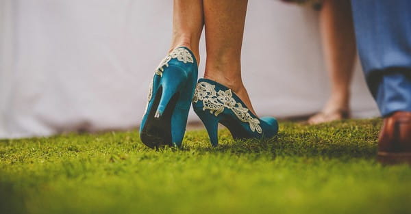 Bride's blue wedding shoes with white lace detail