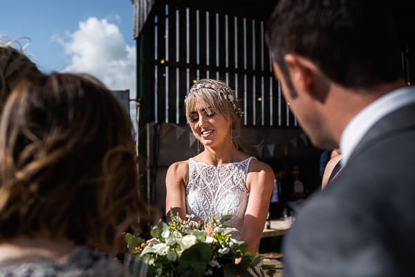 Bride showing guest her bouquet