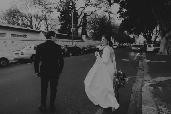 Bride and groom crossing the road