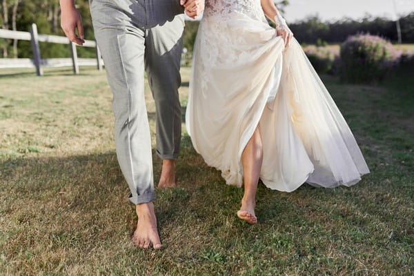 Bride and groom walking barefoot