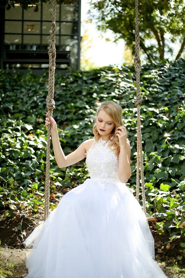 Bride sitting on swing