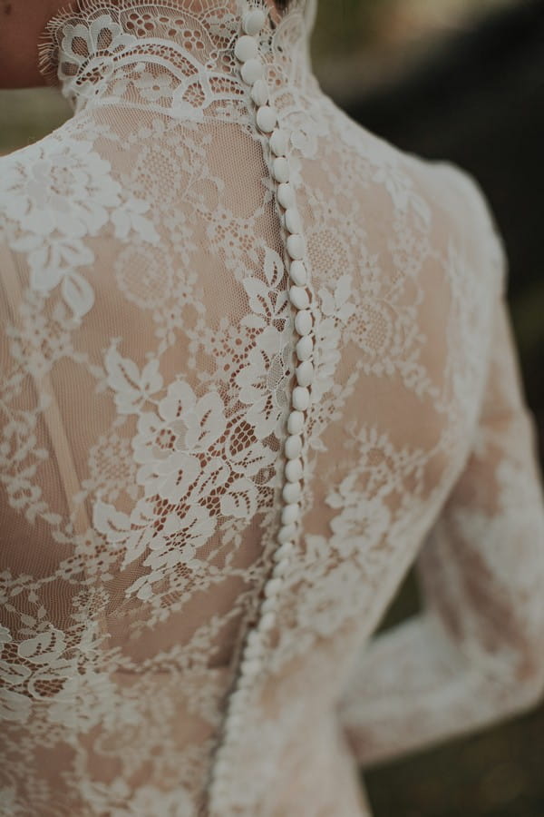 Lace detail and buttons on back of bride's dress