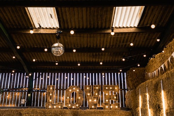 Illuminate love letters and disco ball in cow shed