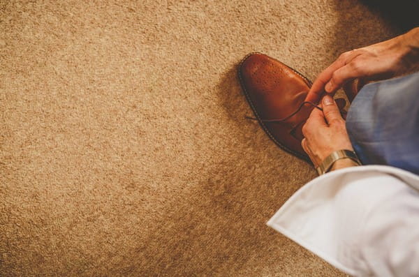 Groom tying shoelaces