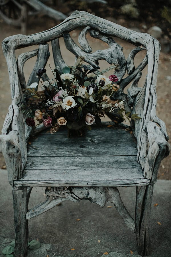 Bride's autumn bouquet on old wooden chair