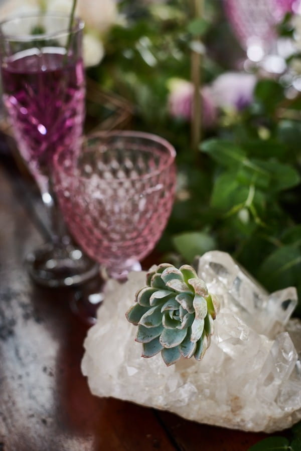 Succulent, clear quartz and purple glass on wedding table