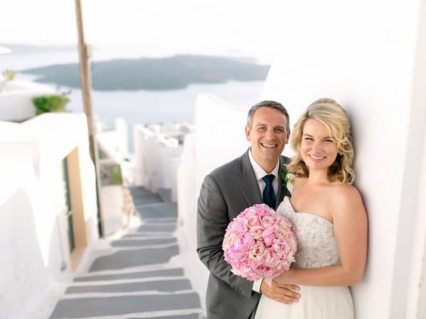 Bride and groom with Santorini street in background