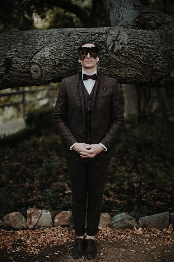 Groom with foliage mask over eyes