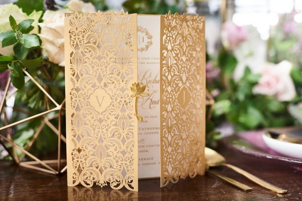 Gold laser-cut wedding stationery