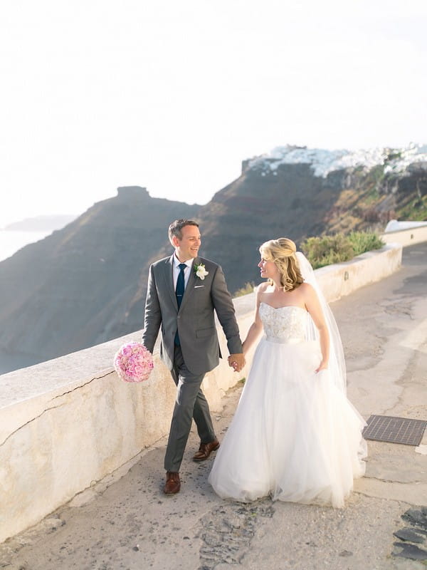 Bride and groom walking holding hands