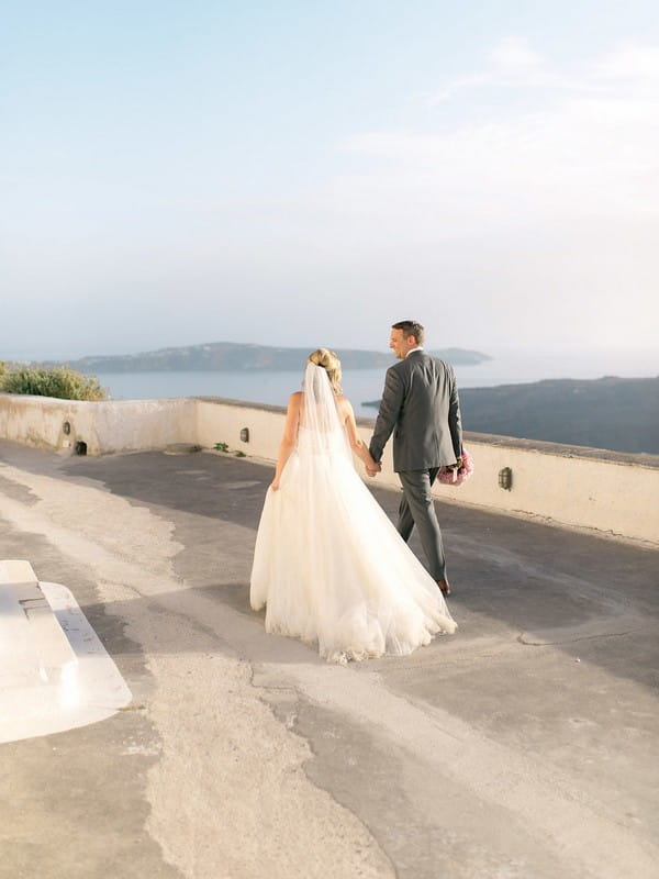 Bride and groom walking holding hands