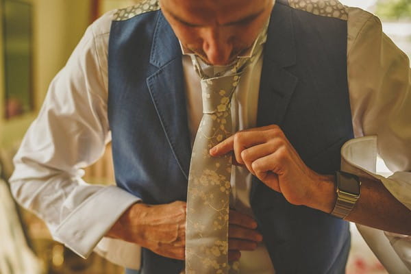 Groom doing up tie