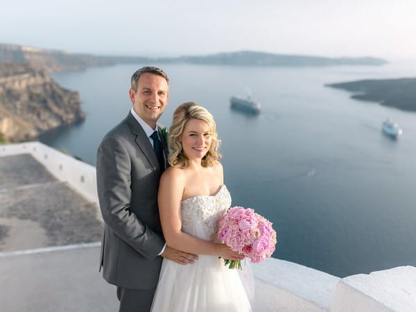 Bride and groom with sea in background