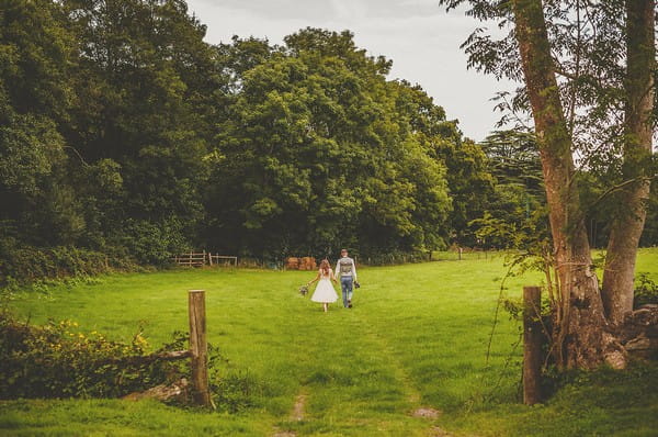 Bride and groom walking in grounds of Colehayes Park