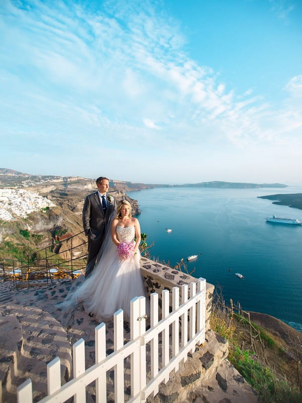 Bride and groom in front of view of Santorini