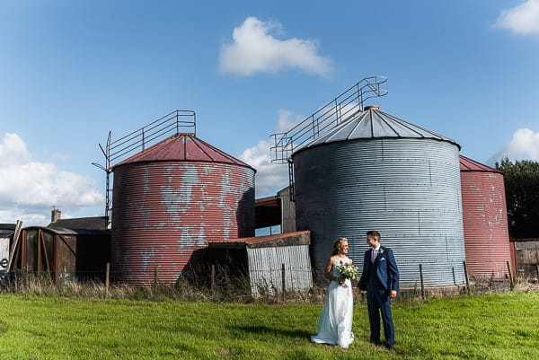 Bride and groom in front of milk tanks