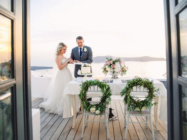 Bride and groom cutting wedding cake