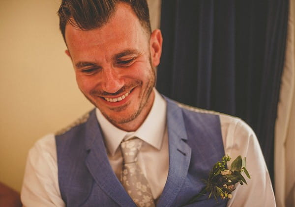 Groom smiling listening to speech