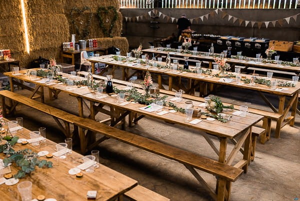 Rustic wedding table styling for cow shed wedding