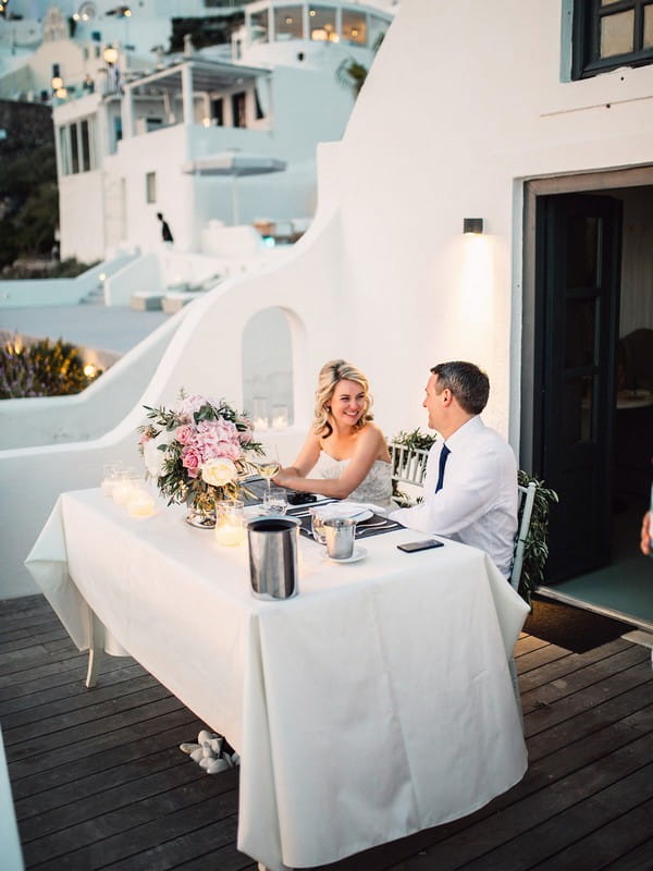 Couple having dinner after elopement in Santorini