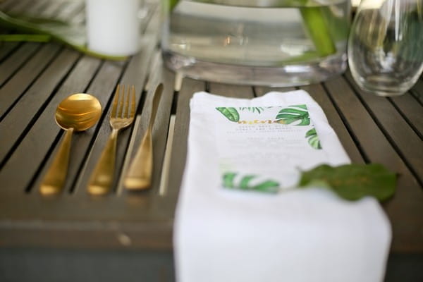 Gold cutlery at wedding place setting