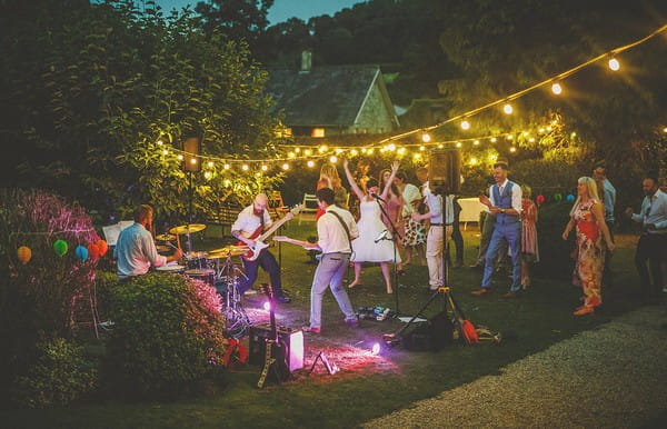 Wedding guests dancing to band