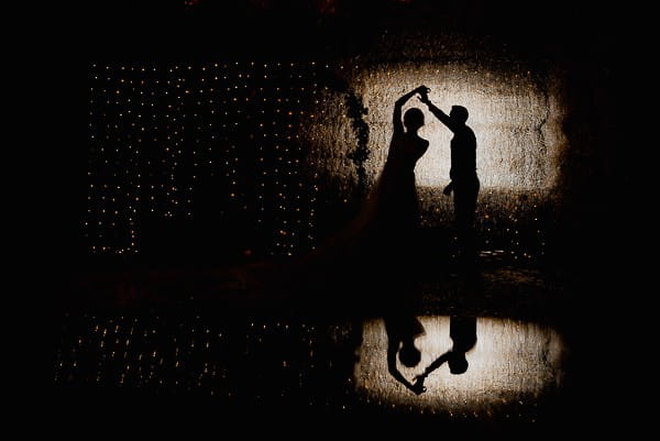 Silhouette of bride and groom dancing