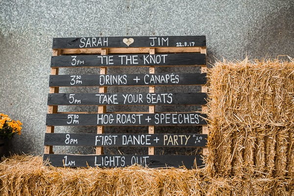 Wedding order of the day written on wooden pallet