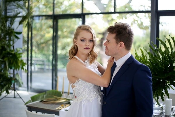 Bride with hand on groom's shoulder