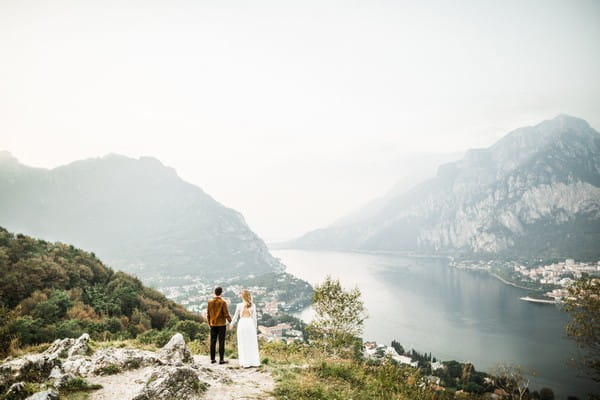 Bride and groom looking at view of Lake Como