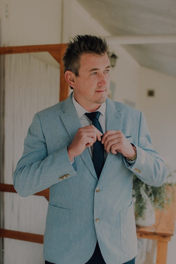 Groom wearing light blue jacket