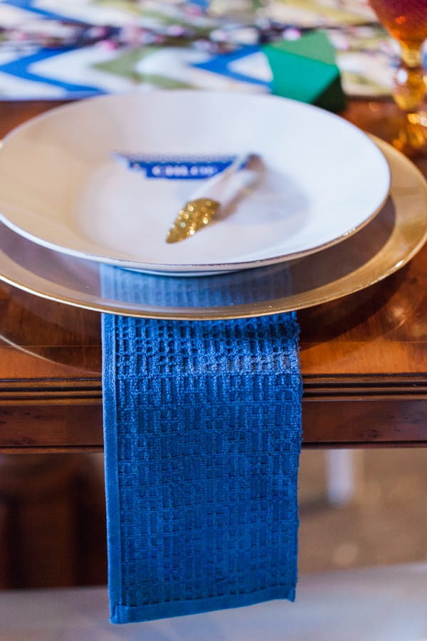 Blue wedding table runner under plate