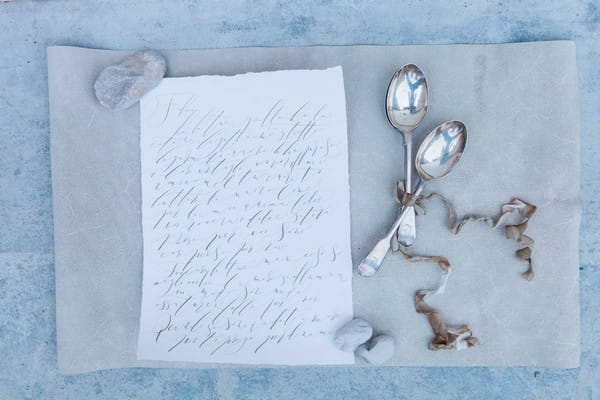 Calligraphy written note with silver spoons