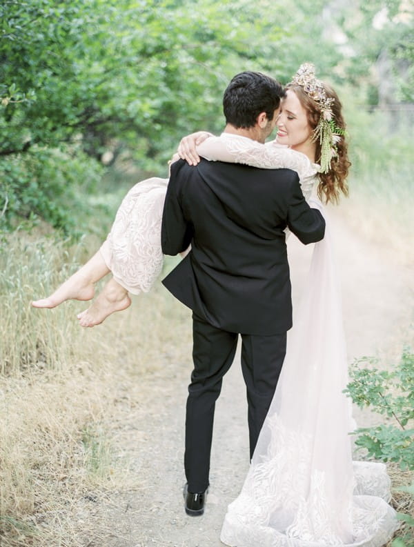 Groom carrying bride