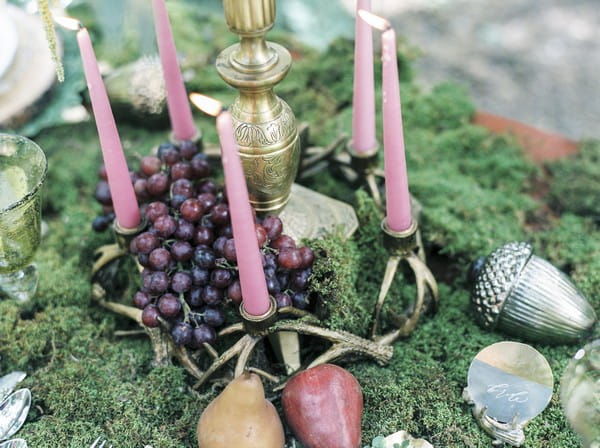 Candles on moss covered wedding table