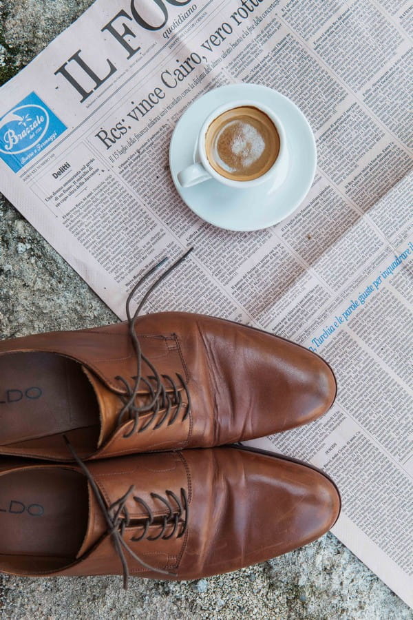 Brown groom shoes on newspaper